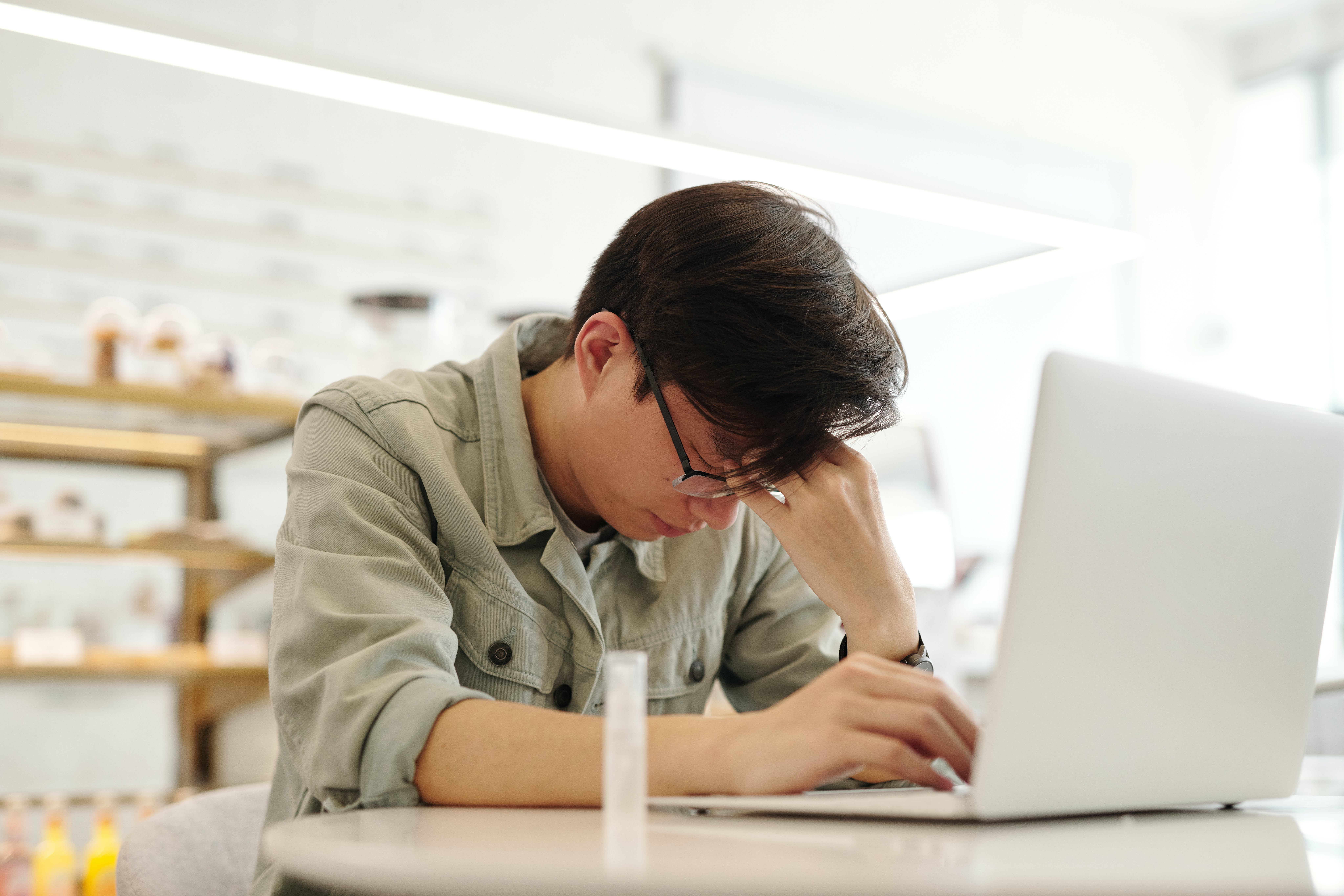 An Asian male suffering from a headache
