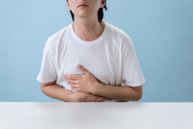 Asian man suffering from constipation