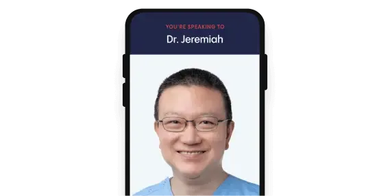 A phone showing a video consult with Dr Jeremiah Tan